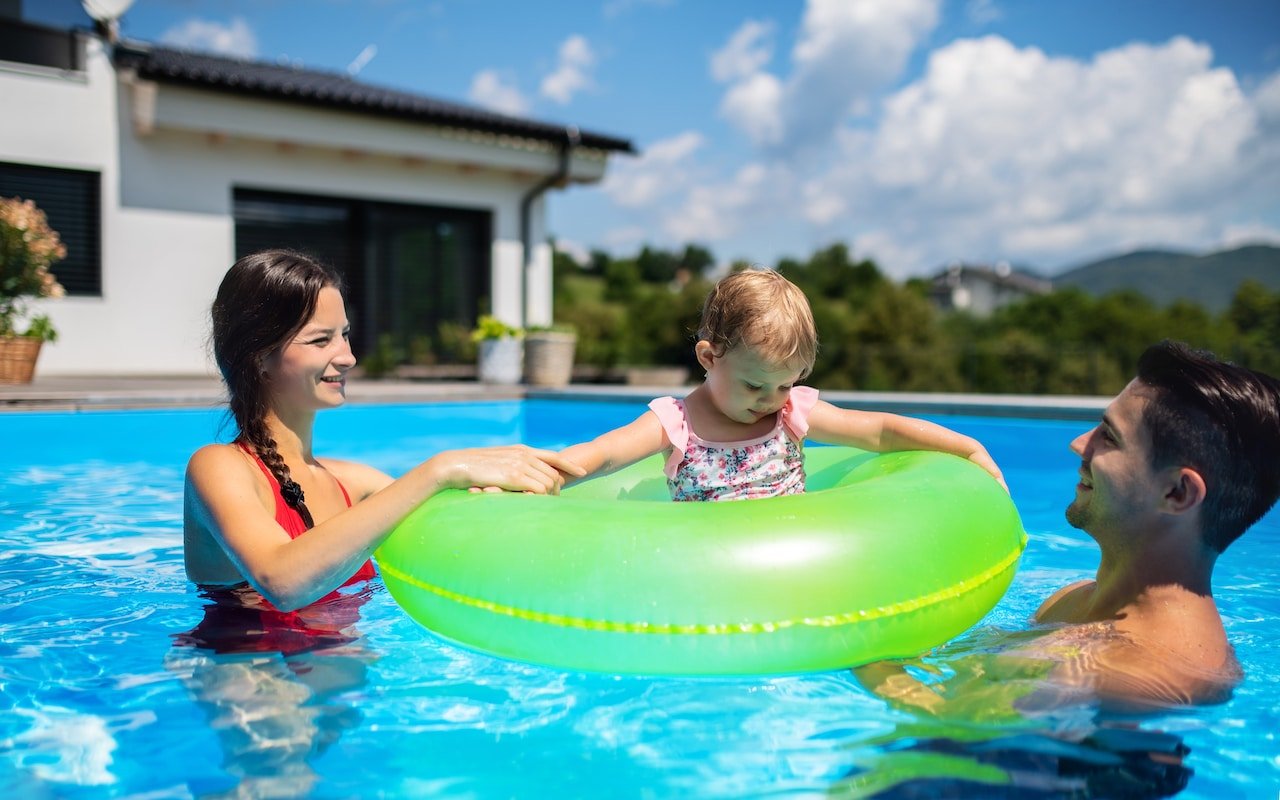 family playing in pool after pool remodel
