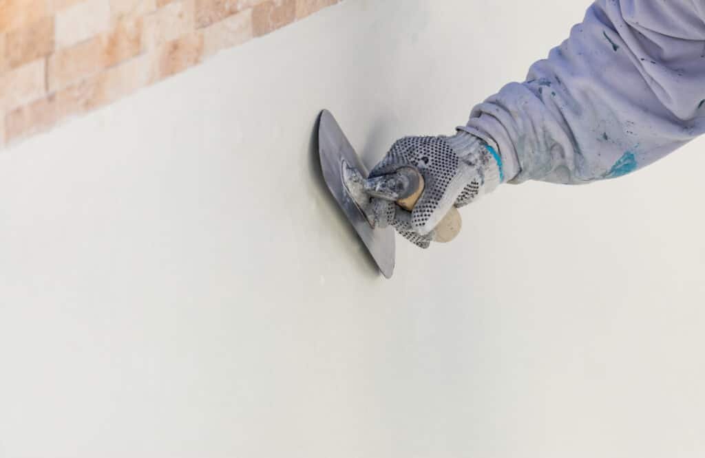 10 Signs That Your Pool Needs To Be Replastered 2 pool builder working on pool replastering