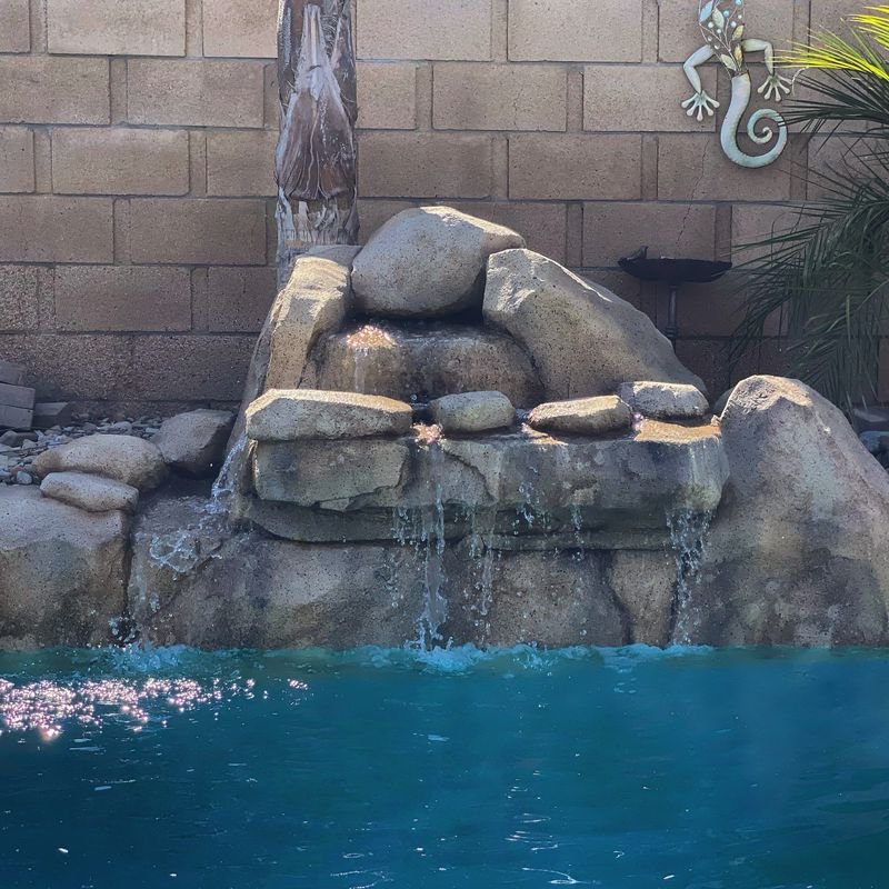Backyard pool with a water fall